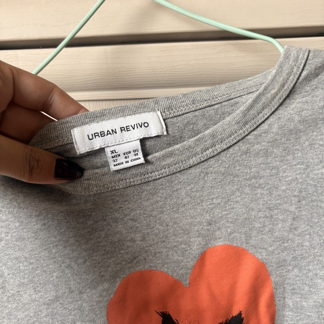 Urban Revivo Top (Category: Shirts) located in Makati City. Submitted by iu__00 (Listing ID 1464391870, Image 2). Description: - Grey t-shirt from Urban Revivo - Size: Xl on tag best fit to med - Features a cute black cat graphic inside an orange heart - Short sleeves and crew neck - Ideal for casual wear.