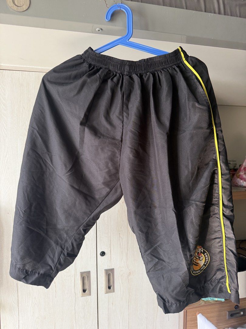 UST PATHFIT UNIFORM (XL) - Shirt and Pants (Category: Activewear) located in Manila. Submitted by deynnnnnn (Listing ID 1464365327, Image 2). Description: - Yellow short-sleeved polo shirt - Black collar and trim - 'FITNESS' logo on chest - Black 3/4 length sports shorts - Elastic waistband on shorts - Yellow piping along sides of shorts - Tiger logo on right leg of shorts - Ideal for workouts and sports activities.