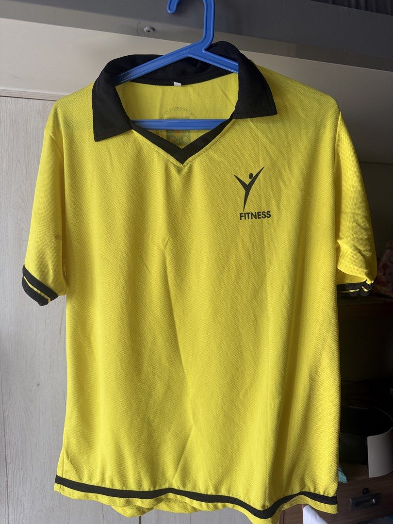 UST PATHFIT UNIFORM (XL) - Shirt and Pants (Category: Activewear) located in Manila. Submitted by deynnnnnn (Listing ID 1464365327, Image 1). Description: - Yellow short-sleeved polo shirt - Black collar and trim - 'FITNESS' logo on chest - Black 3/4 length sports shorts - Elastic waistband on shorts - Yellow piping along sides of shorts - Tiger logo on right leg of shorts - Ideal for workouts and sports activities.