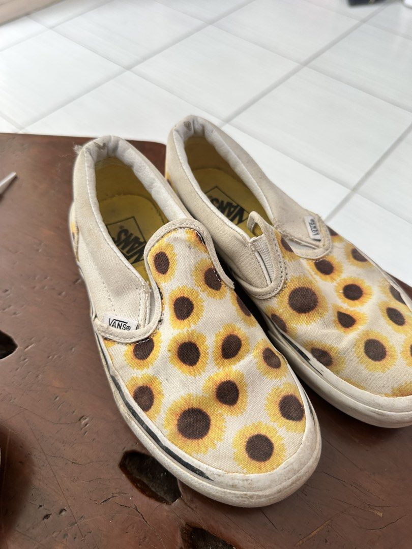 Vans Slip-On Sunflower Print Shoes (Category: Babies & Kids Fashion) located in Leyte. Submitted by handmedownp (Listing ID 1464383813, Image 2). Description: - Classic Vans slip-on style - Fun all-over sunflower print (white canvas with yellow & brown sunflowers) - Elastic side accents for easy on and off - Durable rubber sole - Ideal for casual outings and everyday wear Condition as is sa pic :) needs washing.