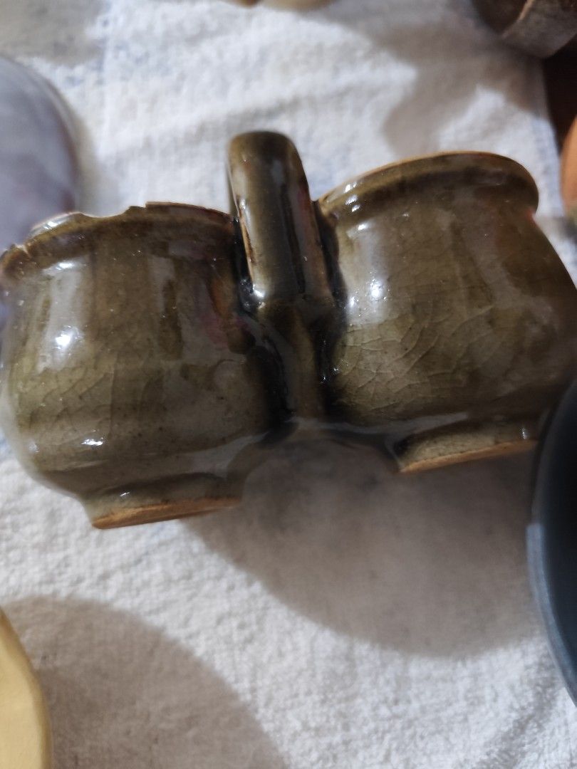 Vintage Ceramic Double Condiment Holder with Handle (Category: Food Organization & Storage) located in Manila. Submitted by marriage031073advocate (Listing ID 1464420410, Image 2). Description: - Unique double-compartment ceramic holder - Rustic, crackled glazed finish - Sturdy handle for easy carrying - Ideal for serving sauces, dips, or spices - Adds vintage charm to any table setting - Great for collectors or unique kitchenware.