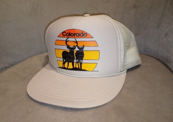 Vintage Colorado Sunset Deer Trucker Hat (Category: Caps & Hats) located in Binangonan. Submitted by yuristalin888 (Listing ID 1464565850, Image 2). Description: Embrace the vintage aesthetic with this classic **Nissin Cap** trucker hat. Featuring a nostalgic front graphic of two deer silhouetted against a warm Colorado sunset, this hat blends retro charm with outdoor style. * **Design:** Bold front print showcasing "Colorado" in retro typography