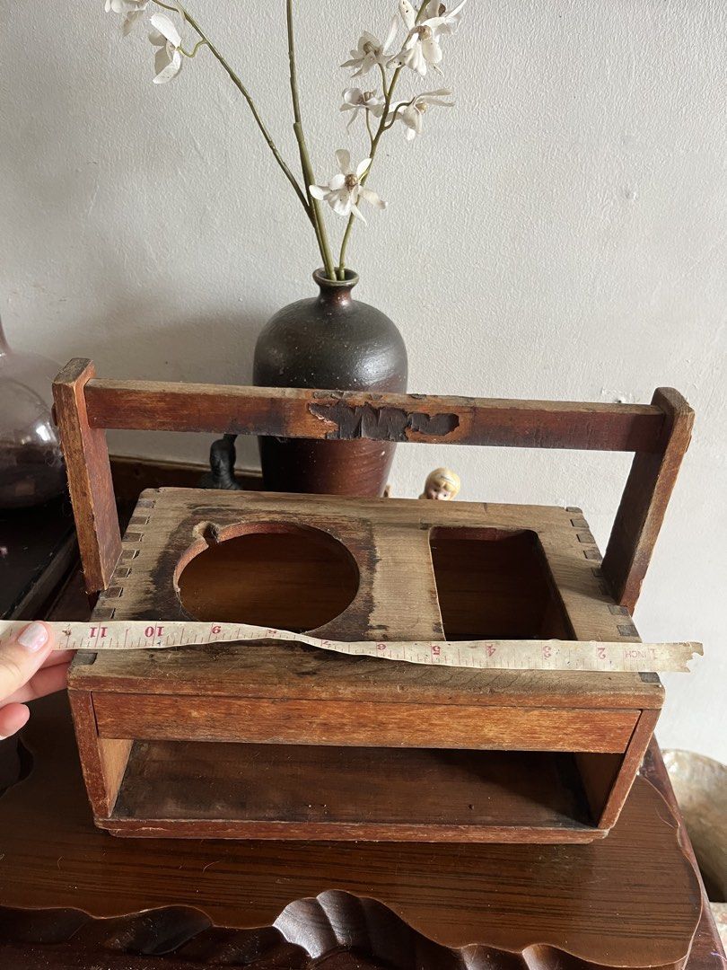 Solid wood tobaco Caddy with Handle and Compartments (Category: Storage Boxes & Baskets) located in Taguig. Submitted by minmin_parker (Listing ID 1464399391, Image 3). Description: - Vintage wooden caddy with a convenient handle. - Two top compartments: one round, one rectangular. - Open shelf space below for additional storage. - Exhibits signs of age and wear, enhancing its vintage appeal. - Ideal for organizing small items or as a charming de