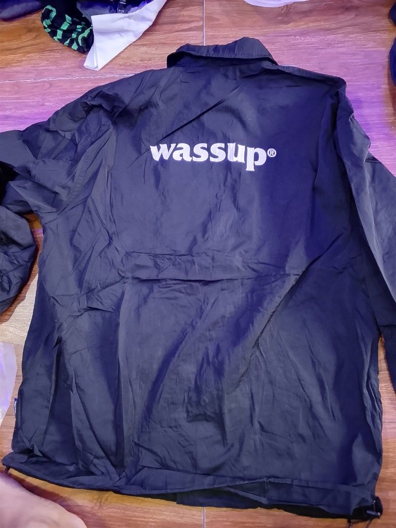 Wassup Black Coach Jacket (Category: Coats, Jackets and Outerwear) located in Las Pinas. Submitted by solisjethr46316 (Listing ID 1464535944, Image 2). Description: - Black Wassup coach jacket - Button-up front with collar - Wassup logo printed on front and back - Lightweight material - Ideal for layering.