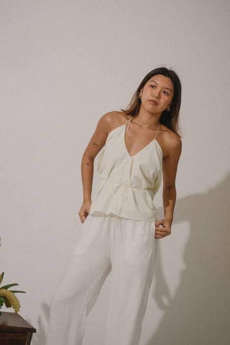Wear Anika Haya Top (Category: Blouses) located in Makati City. Submitted by shopmyarte (Listing ID 1464493052, Image 1). Description: - Cream colored halter neck top - Features a tie waist detail - Comes with matching wide leg pants - Made from lightweight fabric, ideal for warm weather - Comfortable and chic set - Perfect for casual days or beach vacations.