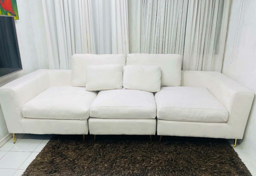 White 3-Seater Sofa with Gold Legs (Category: Sofas) located in Antipolo. Submitted by roselle001 (Listing ID 1464444480, Image 1). Description: - Comfy white 3-seater sofa - Plush cushions for ultimate comfort - Stylish gold legs - Modular design for flexible configurations - Ideal for living rooms and lounges - Approximate dimensions: 115" L x 41" W x 37" H - Comes with decorative throw pillows.