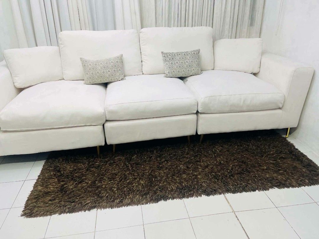 White 3-Seater Sofa with Gold Legs (Category: Sofas) located in Antipolo. Submitted by roselle001 (Listing ID 1464444480, Image 2). Description: - Comfy white 3-seater sofa - Plush cushions for ultimate comfort - Stylish gold legs - Modular design for flexible configurations - Ideal for living rooms and lounges - Approximate dimensions: 115" L x 41" W x 37" H - Comes with decorative throw pillows.