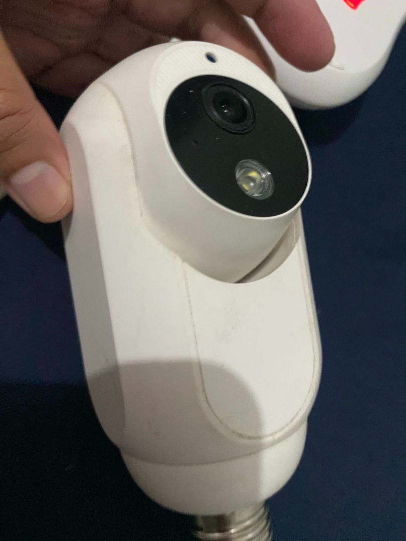 White Bulb Security Camera with Mount (Category: Security Systems & CCTV Cameras) located in Taguig. Submitted by azil16 (Listing ID 1464515292, Image 1). Description: - White security camera designed to screw into a standard light bulb socket. - Features a rotating head for 360-degree panoramic viewing. - Includes mounting base for easy setup. - Ideal for home security and monitoring. - Simple installation process, no complex wiring needed..