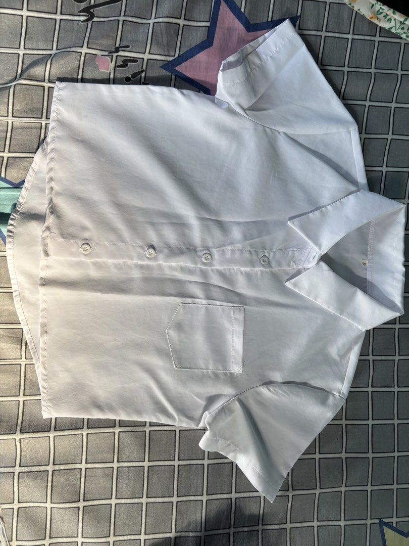 White Button-up top (Category: Blouses) located in Vigan. Submitted by prelovedbyr.1 (Listing ID 1464360166, Image 1). Description: personal preloved item color may vary due to lighting fits xs-s condition: 9/10 flaw: in the shoulder part loc: vigan city, I.S. mop: gcash/maribank mod: J&T.