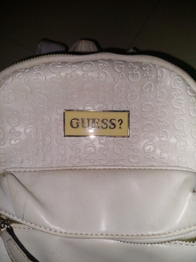 White Guess Backpack with Embossed Gs (Category: Backpacks) located in Manila. Submitted by okeanos (Listing ID 1464365407, Image 2). Description: - White Guess backpack - All-over embossed G pattern - Front pocket with zip and Guess logo stripe - Gold hardware - Adjustable straps - Minor marks on the bag.