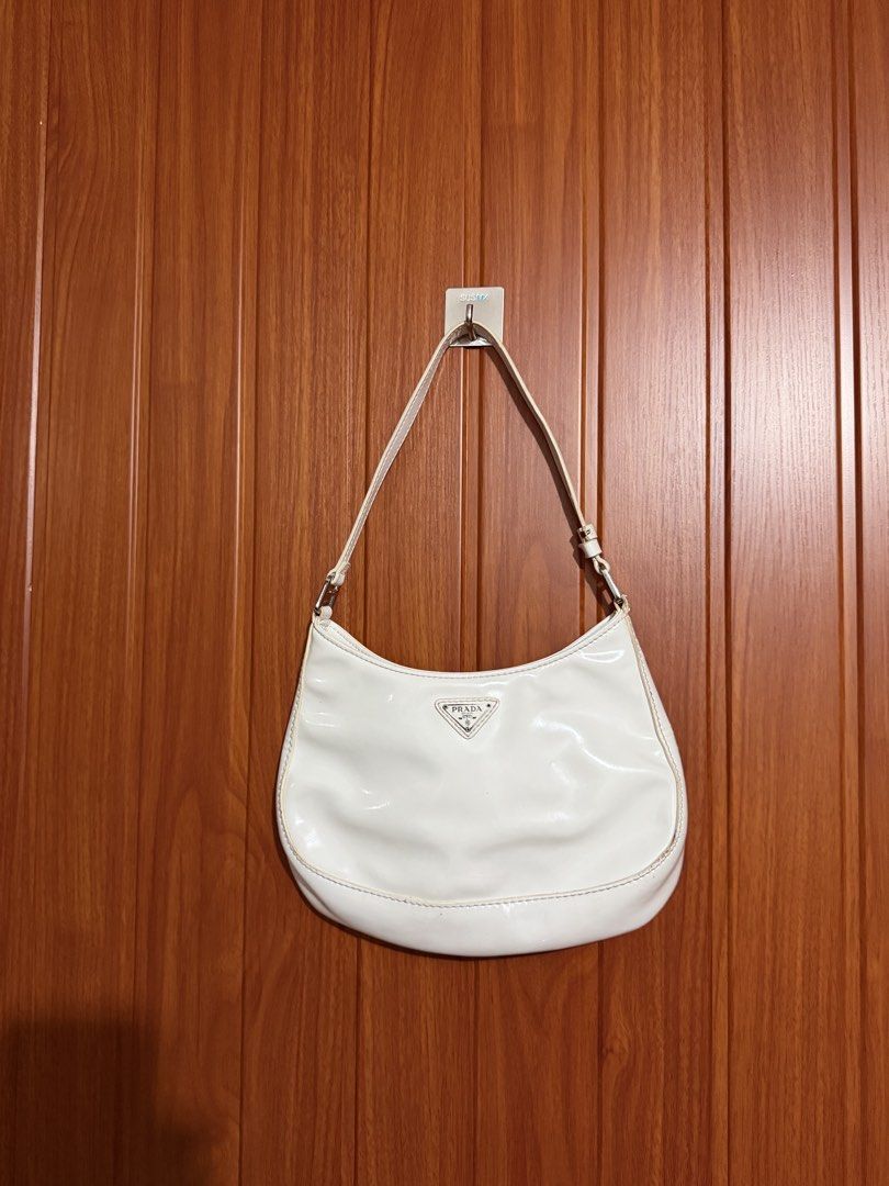 White Patent Leather Prada Shoulder Bag (Category: Luxury Bags & Wallets) located in Manila. Submitted by tlfph (Listing ID 1464540787, Image 1). Description: - Authentic white patent leather Prada shoulder bag - Elegant silver hardware details - Spotless interior for a pristine look - Timeless shoulder bag design, ideal for everyday style - Shows some gentle wear on edges and strap, adding character.