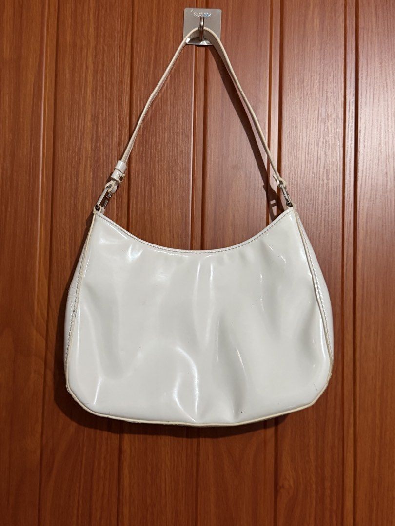 White Patent Leather Prada Shoulder Bag (Category: Luxury Bags & Wallets) located in Manila. Submitted by tlfph (Listing ID 1464540787, Image 3). Description: - Authentic white patent leather Prada shoulder bag - Elegant silver hardware details - Spotless interior for a pristine look - Timeless shoulder bag design, ideal for everyday style - Shows some gentle wear on edges and strap, adding character.