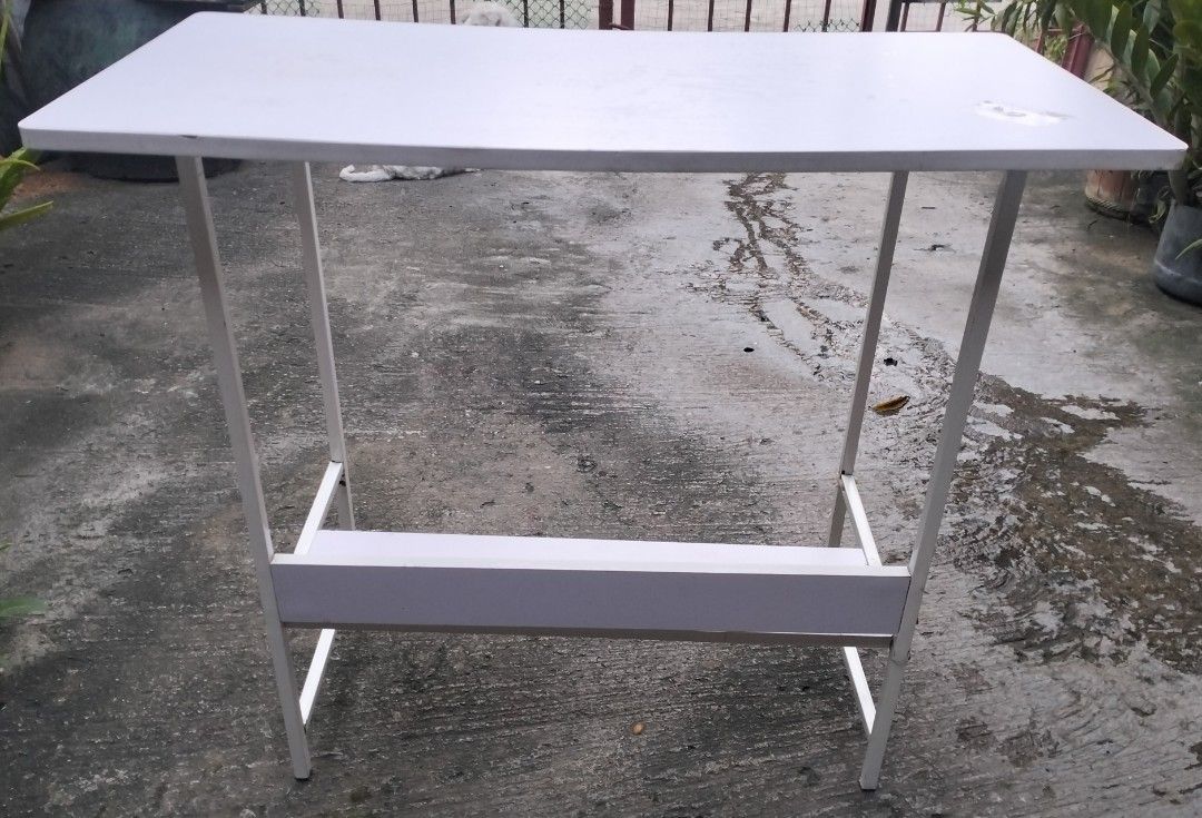 White Table with Shelf (Category: Tables & Sets) located in Bacoor. Submitted by biala17 (Listing ID 1464540890, Image 2). Description: - White table - Features a shelf underneath for extra storage - Metal legs - Top surface has some light marks - Ideal for small spaces or as a temporary desk.