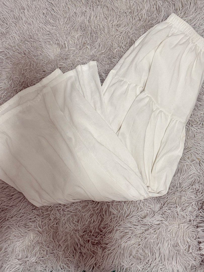 White Tiered Wide Leg Pants (Category: Jeans) located in Las Pinas. Submitted by erichf (Listing ID 1464565838, Image 1). Description: - White tiered pants - Comfortable elastic waistband - Flowy and breathable material - Ideal for casual wear or lounging - Versatile for styling with various tops - Perfect for warm weather.