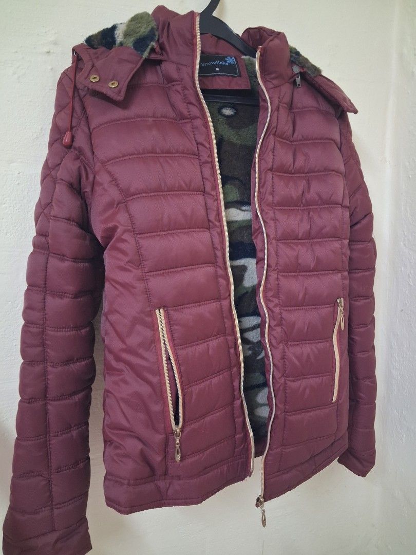 Winter Jacket (Category: Coats, Jackets and Outerwear) located in Singapore. Submitted by carpe_diem. (Listing ID 1464443717, Image 1). Description: - Cozy maroon winter jacket with hat - Features a cool camouflage lining - Zipper closure with front pockets - Ideal for cold weather, down to 8-10 degree - Bought at Universal Traveller event $40, let go at loss at $27 - Stated M size but more to S size, suitable for kids or adult weigh below 43kg.