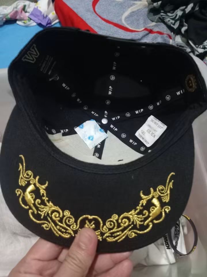 WIP Cap Black with Gold Axe Embroidery (Category: Caps & Hats) located in Quezon City. Submitted by fierce_jordanmatthew (Listing ID 1464569096, Image 2). Description: - Black cap with striking gold axe embroidery on the front. - Features ornate gold embroidery detailing on the brim. - Interior shows WIP branding. - Comes with a silica gel packet for preservation. - An excellent addition for any cap collector's display. -Wit cert.