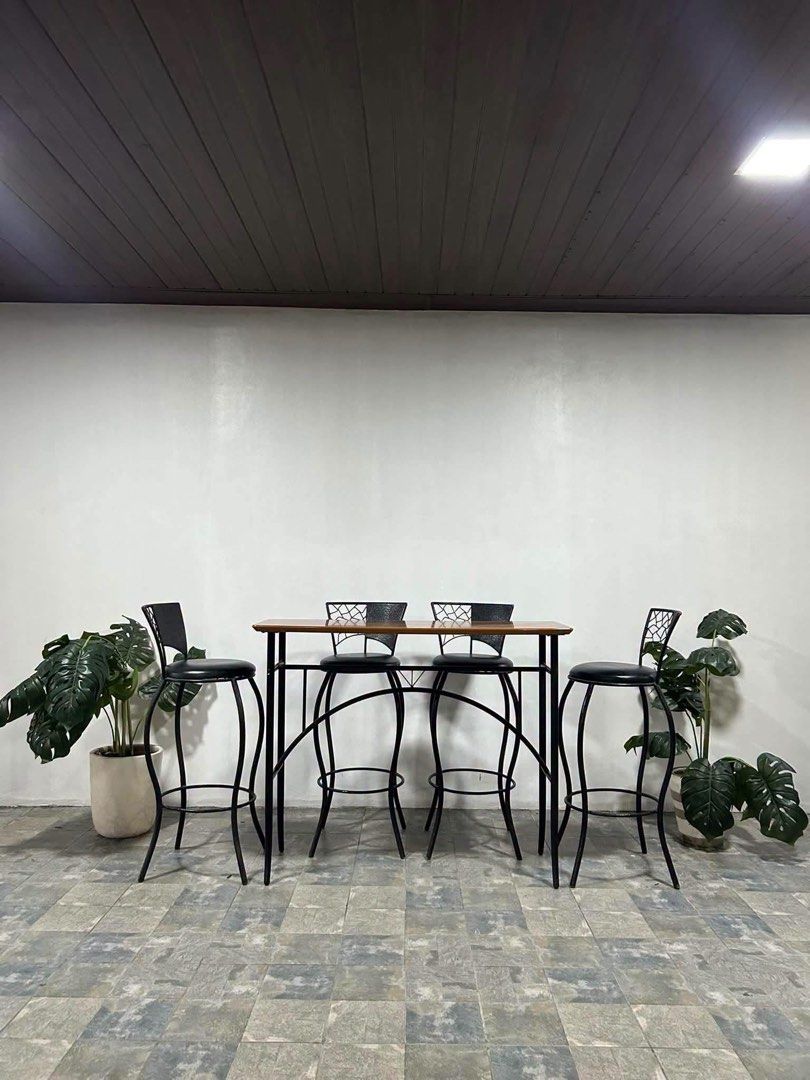 Wooden Bar Table with 4 Black Metal Stools (Category: Tables & Sets) located in Baguio. Submitted by nileh (Listing ID 1464377511, Image 1). Description: Imported Bar Table n Bar Chairs from Japan 47x18x38in/ Bar Table 40x30x14in/ Bar Chairs Complete Set Solid Wood Bar table 4pcs Bar Chairs Leather Padded Heavy duty No issue Good Condition Minor Scratch From Japan.