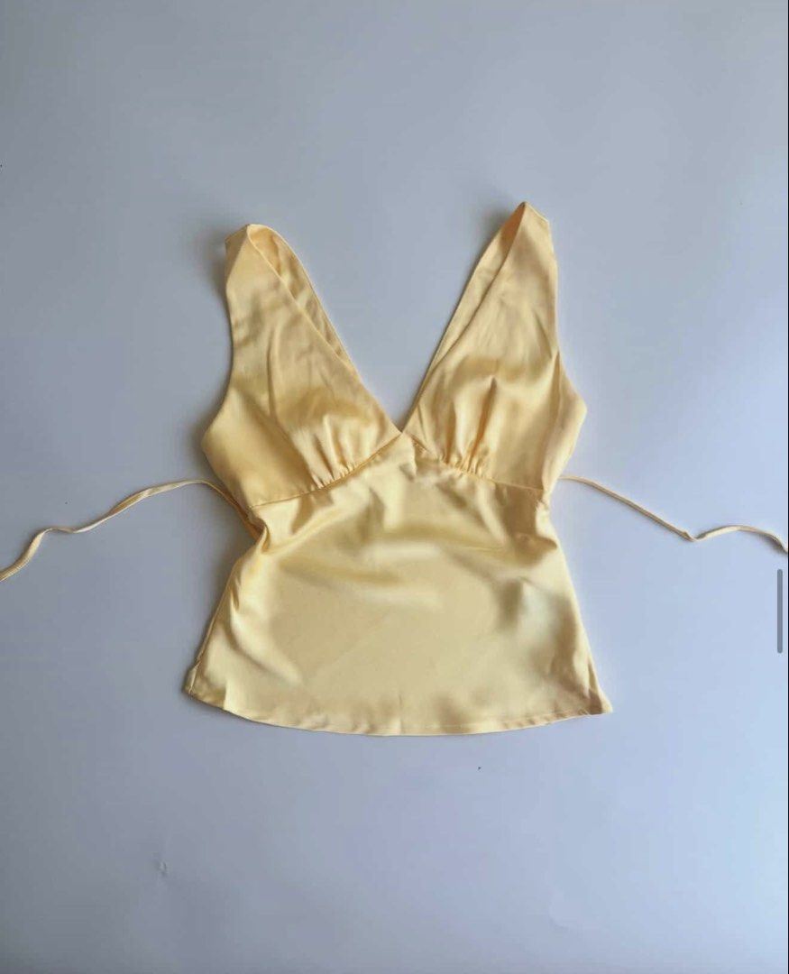 Yellow Satin Halter Neck Cami Top (Category: Sleeveless) located in Quezon City. Submitted by zzzchooeh (Listing ID 1464427958, Image 1). Description: - Cute yellow satin cami top - Halter neck style - Tie-back closure - Lovely sheen fabric - Versatile for dressing up or down - Ideal for summer evenings or a night out.