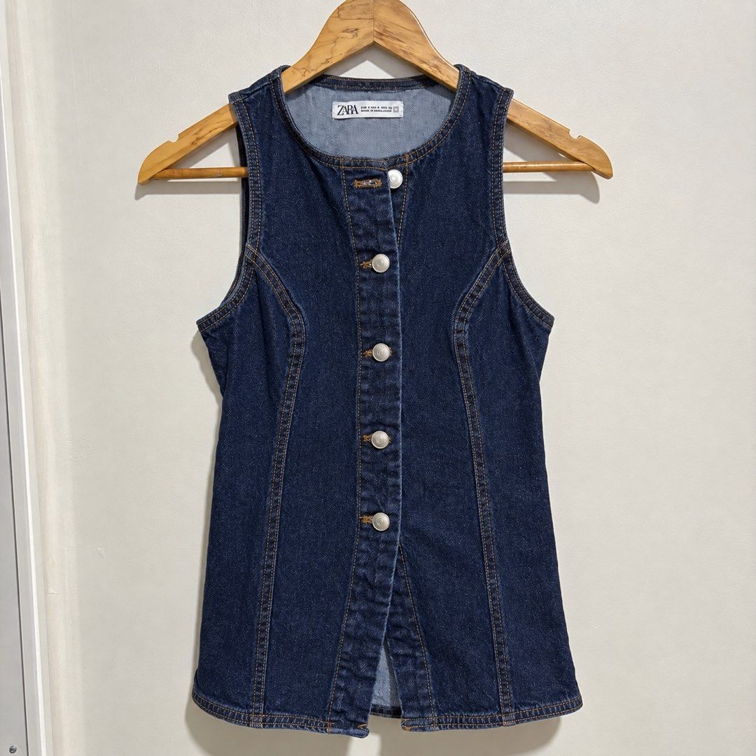 Zara Denim Sleeveless Vest (Category: Sleeveless) located in Subic. Submitted by ysbllrs (Listing ID 1464555747, Image 1). Description: - Zara dark wash denim vest - Sleeveless design - Button-up front closure - Rounded neckline - Tailored seams for a flattering fit - Versatile layering piece for t-shirts or dresses.