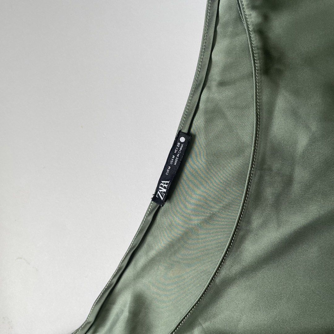 Zara One Shoulder Silk Top - Olive Green (Category: Sleeveless) located in Pasay City. Submitted by lovedbyzea (Listing ID 1464537244, Image 3). Description: - Zara olive green one-shoulder top - Features a ruched detail on the strap - Made of silky material - Versatile: perfect for dressing up or down - Size: Medium (M).