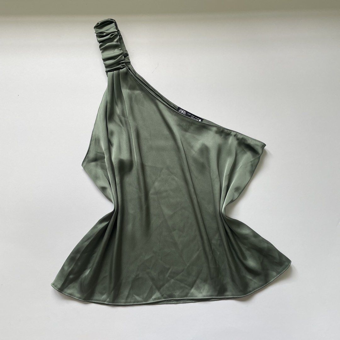 Zara One Shoulder Silk Top - Olive Green (Category: Sleeveless) located in Pasay City. Submitted by lovedbyzea (Listing ID 1464537244, Image 1). Description: - Zara olive green one-shoulder top - Features a ruched detail on the strap - Made of silky material - Versatile: perfect for dressing up or down - Size: Medium (M).