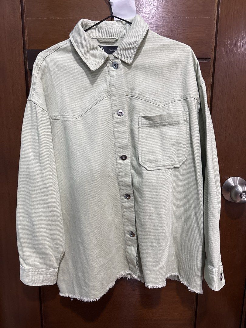 Zara Oversized Light Green Denim Shirt Jacket (Category: Coats, Jackets and Outerwear) located in Mandaluyong City. Submitted by clothescarousel (Listing ID 1464527579, Image 1). Description: - Zara Oversized Denim Shirt - Color: Light Green - Features: Raw hem detail, button-up front, chest pocket - Styling: Great worn open or closed, ideal for layering.