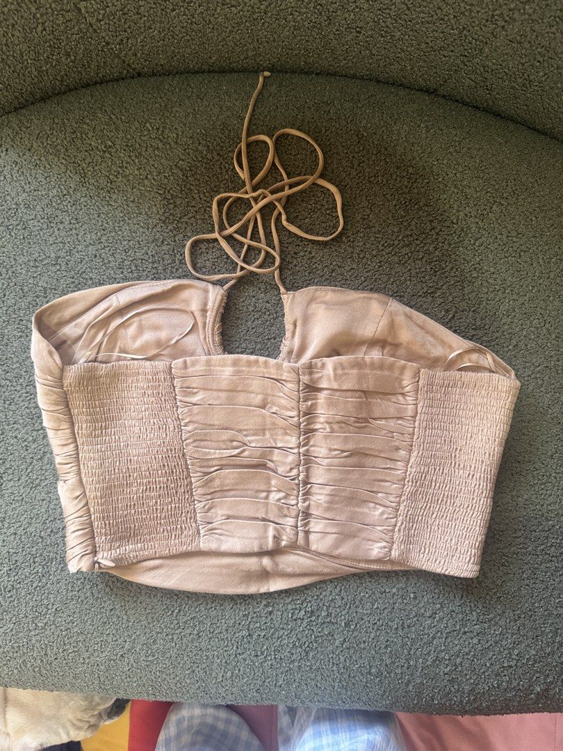 ZARA Ruched Halter Neck Crop Top (Category: Sleeveless) located in Cebu City. Submitted by stayseesells (Listing ID 1464365946, Image 2). Description: - ZARA halter neck crop top - Color: Beige/Champagne - Ruched detailing all over - Smocked back for a comfortable fit - Ties at the neck - Versatile: perfect for dressing up or down, night outs, or special occasions.