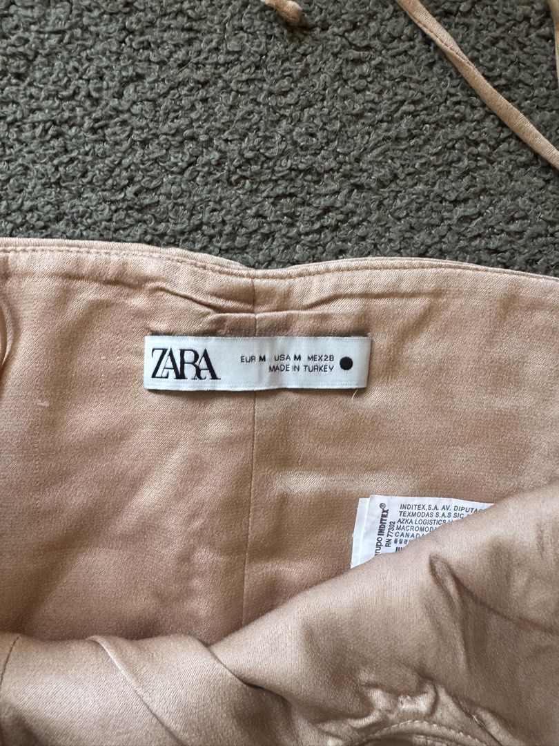 ZARA Ruched Halter Neck Crop Top (Category: Sleeveless) located in Cebu City. Submitted by stayseesells (Listing ID 1464365946, Image 3). Description: - ZARA halter neck crop top - Color: Beige/Champagne - Ruched detailing all over - Smocked back for a comfortable fit - Ties at the neck - Versatile: perfect for dressing up or down, night outs, or special occasions.