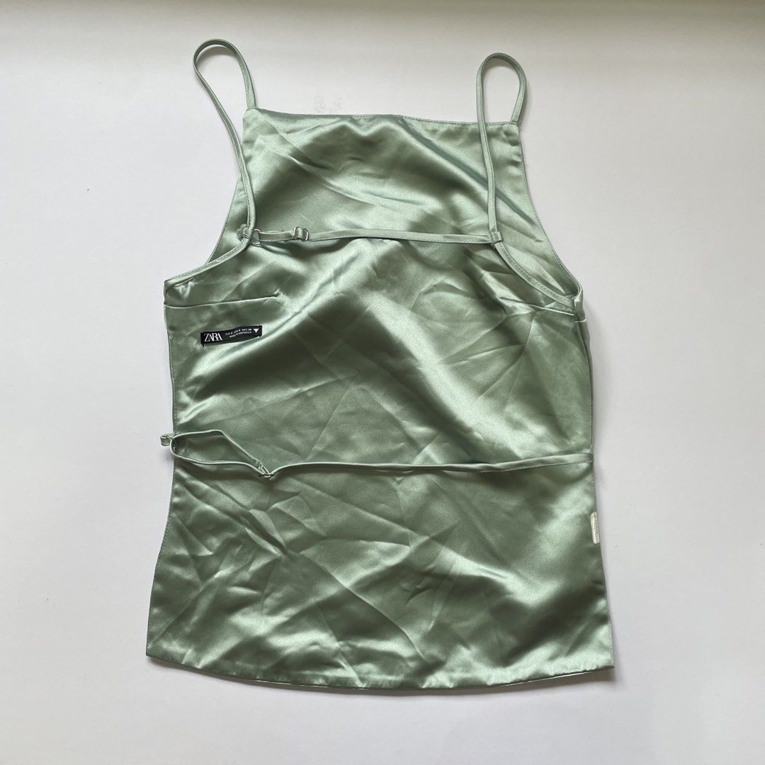 Zara Satin Backless Top Sage Green (Category: Sleeveless) located in Pasay City. Submitted by lovedbyzea (Listing ID 1464423773, Image 2). Description: - Zara sage green satin cami top - Features adjustable straps - Stylish tie detail at the back - Perfect for dressing up or down.