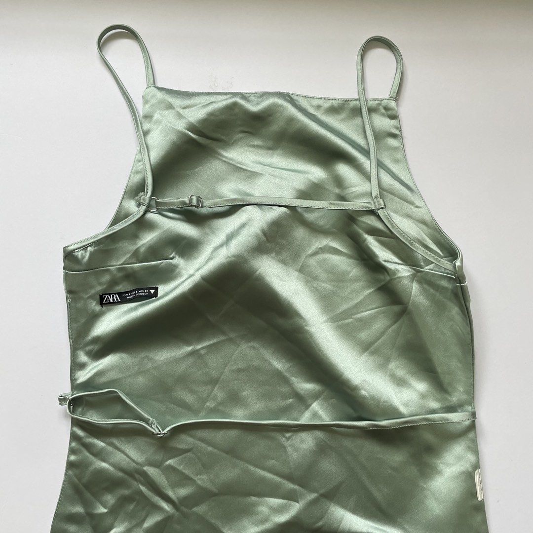 Zara Satin Backless Top Sage Green (Category: Sleeveless) located in Pasay City. Submitted by lovedbyzea (Listing ID 1464423773, Image 3). Description: - Zara sage green satin cami top - Features adjustable straps - Stylish tie detail at the back - Perfect for dressing up or down.