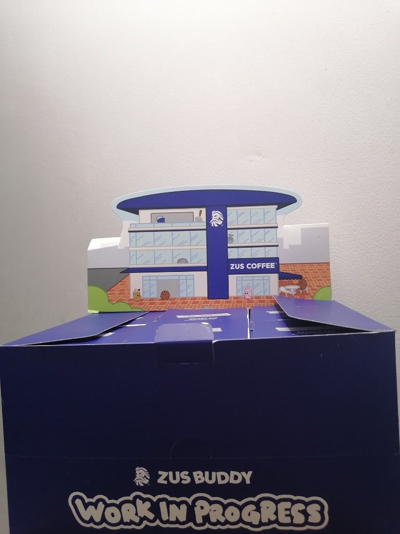 Zus Coffee​ Buddy Work In Progress Box (Category: Designer & Blind Box Toys) located in Caloocan City. Submitted by noellist (Listing ID 1464490519, Image 1). Description: - Collectible Zus Buddy Box - 'Work In Progress' edition selling as set only - Features a cute Zus Coffee building design on top - Contains smaller boxes like - Ideal for fans of Zus Coffee.