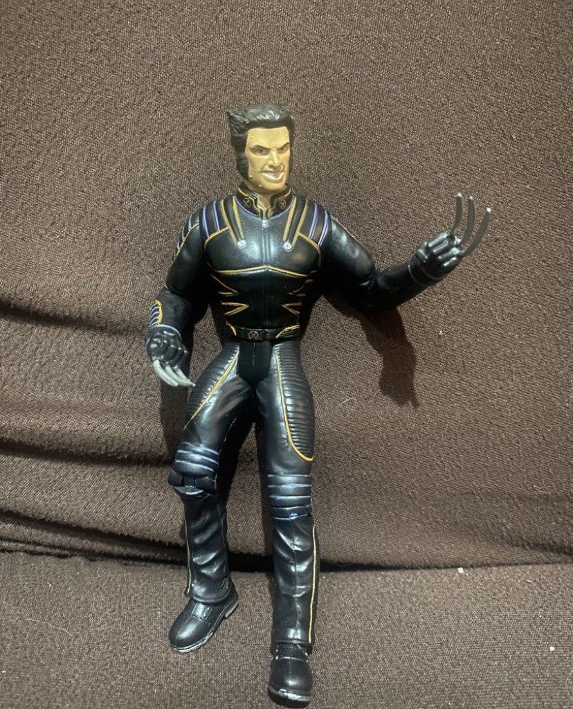 2000's X-Men Wolverine Action Figure with Claws (Category: Figurines & Statues) located in Binan City. Submitted by maggierabi01434 (Listing ID 1464764408, Image 1). Description: - Character: Wolverine from X-Men - Outfit: Black leather-style tactical suit with gold piping and X logo belt buckle - Features: Posed with extended claws on both hands, stands on its own - Condition: Joints move normally, minimal paint wear, clean overall.