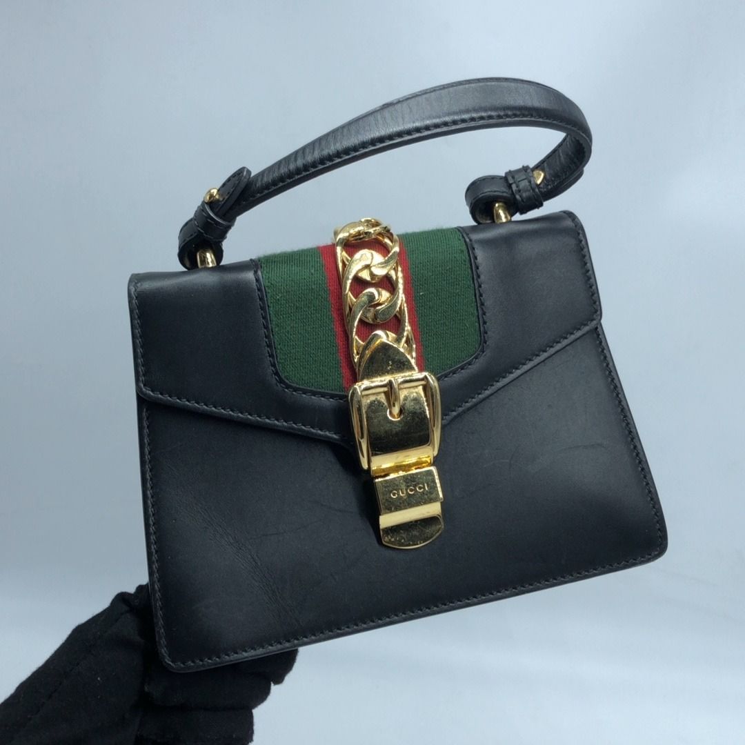 267009462 GUCCI BAG SYLVIE 470270 MINI TOP HANDLE MISSING STRAP (Category: Luxury Bags & Wallets) located in Taguig. Submitted by ecoring.ph (Listing ID 1464589027, Image 1). Description: ◆CONDITION: B- ◆DESCRIPTIONS: (Other defects/info:) OUTER: The body of the bag is scratched, scuffed, stained, dirty, wrinkled, and deformed, has press marks, and shows signs of use. The bottom and bottom corners of the bag are scratched, scuffed, stained, dirty