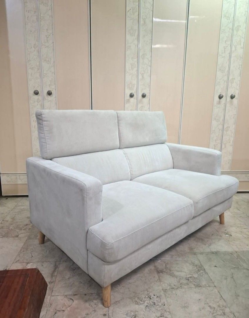 2-Seater Sofa with Wooden Legs (Category: Sofas) located in Antipolo. Submitted by roselle001 (Listing ID 1464647454, Image 1). Description: - Comfortable 2-seater sofa - Upholstered in soft, light grey fabric - Features clean lines and modern wooden legs - Ideal for apartments or smaller living spaces - Easy to maintain and clean.
