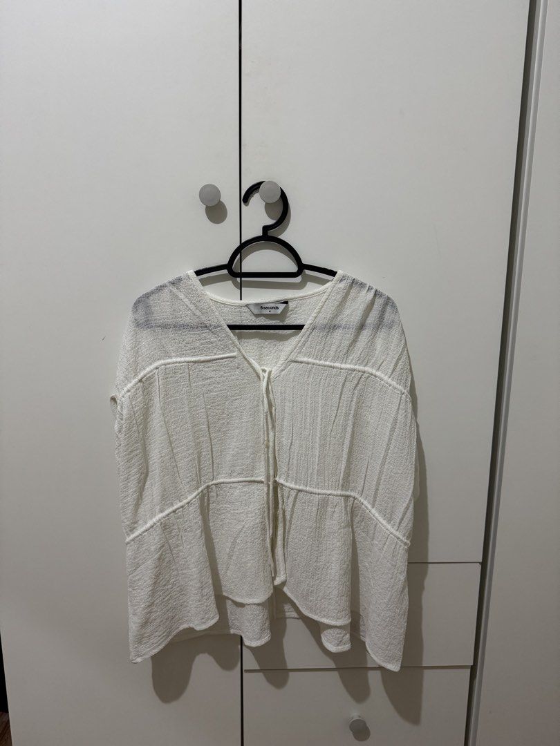 8 Seconds White Textured V-Neck Tie Blouse Size M (Category: Blouses) located in Manila. Submitted by ivorysmile29717 (Listing ID 1464572805, Image 1). Description: - White textured blouse from 8 Seconds - V-neck with adjustable tie detail - Short sleeves - Lightweight and breathable fabric - Perfect for casual outings or dressing up - Size: Medium (M).