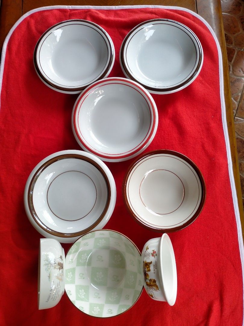 8pcs Ceramic Bowls and Plates Set (Category: Dinnerware & Cutlery) located in Manila. Submitted by margeventa (Listing ID 1464637298, Image 3). Description: Selling a set of 8 ceramic bowls and plates. Includes 4 plates with brown or orange rims, measuring 8"/1" and 6.8"/1.8" deep. Also includes 4 bowls: one with a green apple & flower design (6"/2.5" deep), one Jester brown shallow bowl (5"/1.5" deep), and one Rabbit School shallow bowl (4.8"/1.