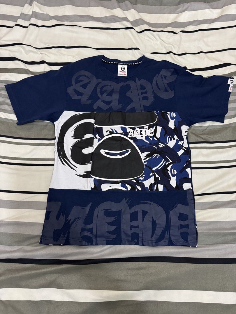 A Bathing Ape Aape Navy Camo Patchwork T-Shirt XL (Category: Tshirts & Polo Shirts ) located in Bulacan. Submitted by alshopie (Listing ID 1464608677, Image 1). Description: - Navy blue Aape t-shirt - Size XL - Cool patchwork design - Features iconic ape head logo - Includes camo print accents - Made of 100% cotton - Please check photos for detailed condition.