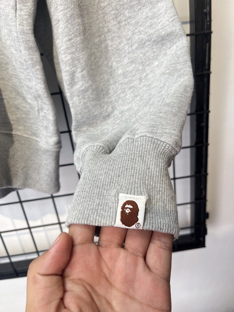 A Bathing Ape BAPE Full Zip Hoodie Grey Camo Lining (Category: Hoodies) located in Taal. Submitted by thrift_deals23 (Listing ID 1464676166, Image 2). Description: - Grey full zip hoodie from A Bathing Ape - Features iconic BAPE camo print on the inside lining - BAPE logo on the zipper pull - Ribbed cuffs and hem - Ideal for everyday wear.