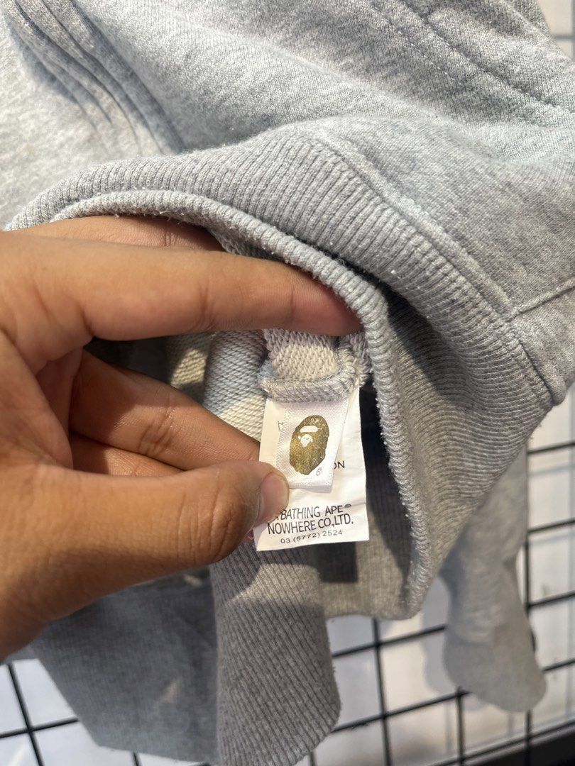 A Bathing Ape BAPE Full Zip Hoodie Grey Camo Lining (Category: Hoodies) located in Taal. Submitted by thrift_deals23 (Listing ID 1464676166, Image 3). Description: - Grey full zip hoodie from A Bathing Ape - Features iconic BAPE camo print on the inside lining - BAPE logo on the zipper pull - Ribbed cuffs and hem - Ideal for everyday wear.