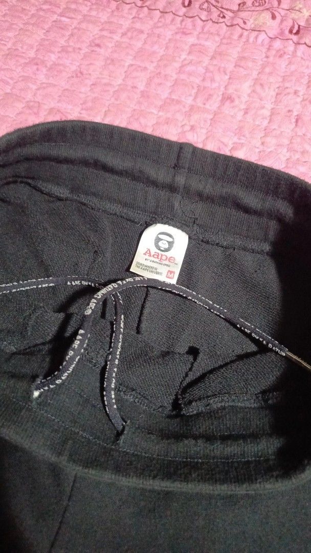 AAPE By A Bathing Ape Black Sweatpants Size M (Category: Joggers) located in Monkayo. Submitted by thrift_ni_lerio (Listing ID 1464728830, Image 3). Description: - Brand: AAPE - Color: Black with white branding graphics - Size: Medium (M) - Fit: Regular fit - Material: Soft cotton blend - Features: Drawstring waistband with branded aglets, elastic cuffs, and back pocket graphic - Condition: Inner tags and care labels intact.