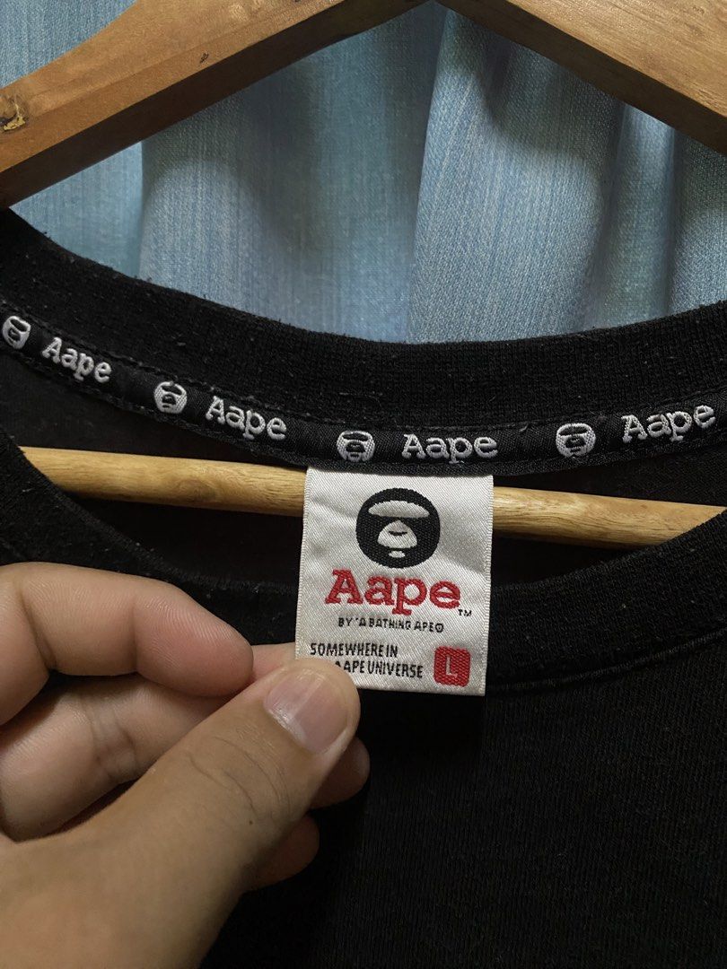 AAPE BY A BATHING APE T-Shirt Size L (Category: Tshirts & Polo Shirts ) located in Dagupan City. Submitted by junkfiles. (Listing ID 1464669532, Image 2). Description: - Brand: AAPE BY A BATHING APE - Color: Black - Size: L (check label for details) - Material: 100% Cotton - Features: Front graphic print with repeated brand name - Style: Great for casual wear.