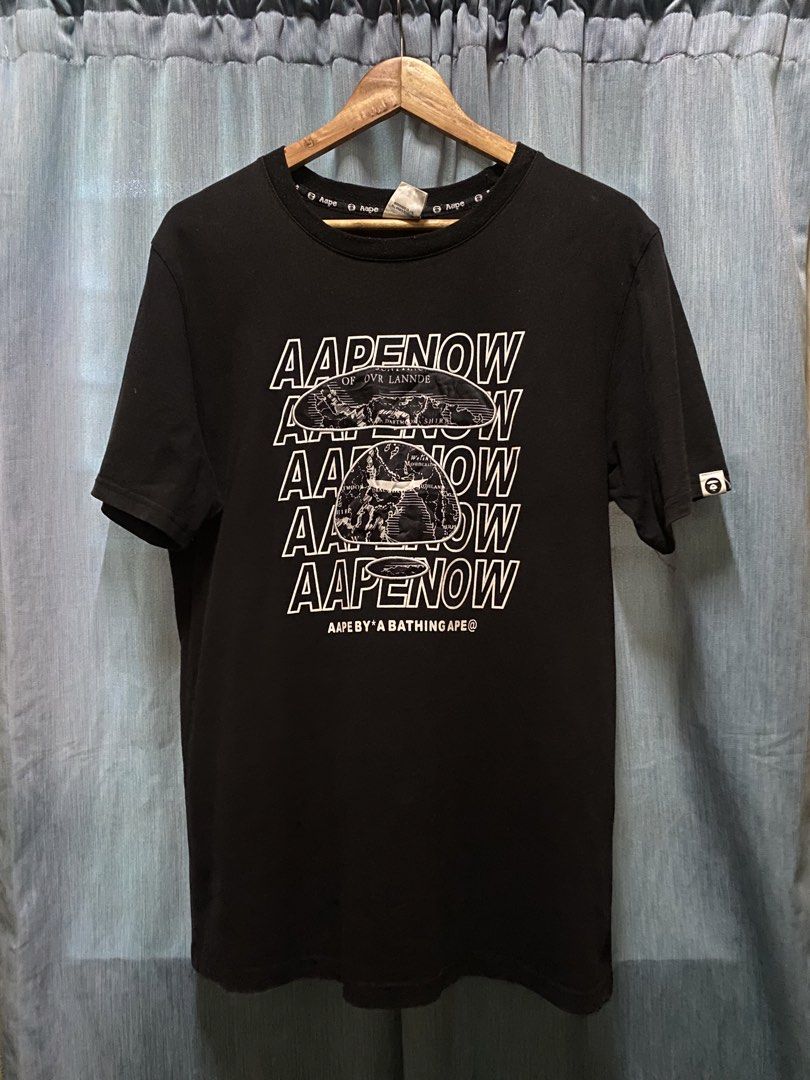AAPE BY A BATHING APE T-Shirt Size L (Category: Tshirts & Polo Shirts ) located in Dagupan City. Submitted by junkfiles. (Listing ID 1464669532, Image 1). Description: - Brand: AAPE BY A BATHING APE - Color: Black - Size: L (check label for details) - Material: 100% Cotton - Features: Front graphic print with repeated brand name - Style: Great for casual wear.