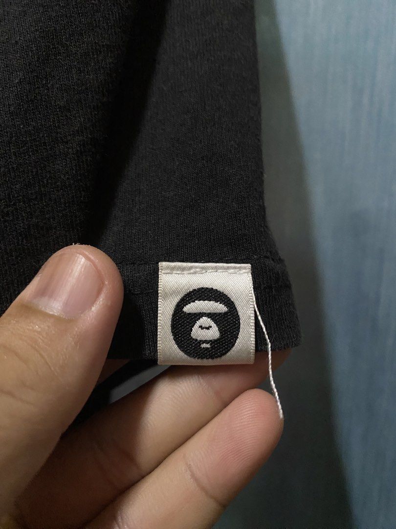 AAPE BY A BATHING APE T-Shirt Size L (Category: Tshirts & Polo Shirts ) located in Dagupan City. Submitted by junkfiles. (Listing ID 1464669532, Image 3). Description: - Brand: AAPE BY A BATHING APE - Color: Black - Size: L (check label for details) - Material: 100% Cotton - Features: Front graphic print with repeated brand name - Style: Great for casual wear.