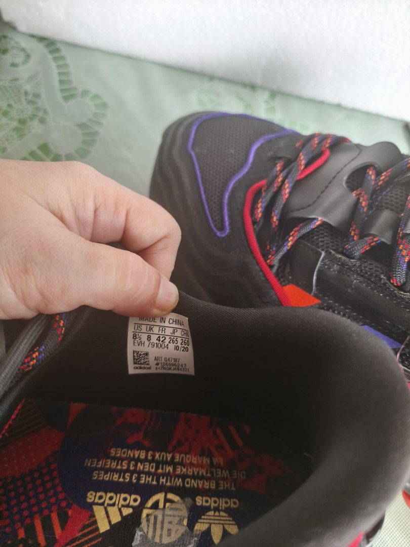 Adidas (Category: Sneakers) located in San Juan City. Submitted by vingabby (Listing ID 1464571147, Image 3). Description: - Adidas Ozweego Sneakers - Color: Black with Red & Purple Accents - Laces: Black with Red & Purple Threads - Size: 8.5 UK / 42 EU - Sole: Black with Red Detailing - Made in China - Date Code: 10/20.