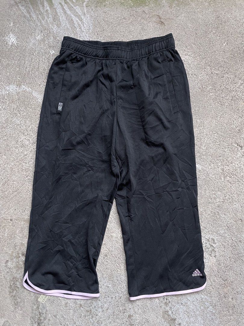 Adidas Black 3/4 Length Athletic Shorts (Category: Activewear) located in Siniloan. Submitted by rethr1ft (Listing ID 1464611437, Image 1). Description: - Black Adidas shorts - 3/4 length - Elastic waistband with drawstring - Side pockets - Pink trim along the hem - Ideal for sports or casual wear - Made in China.