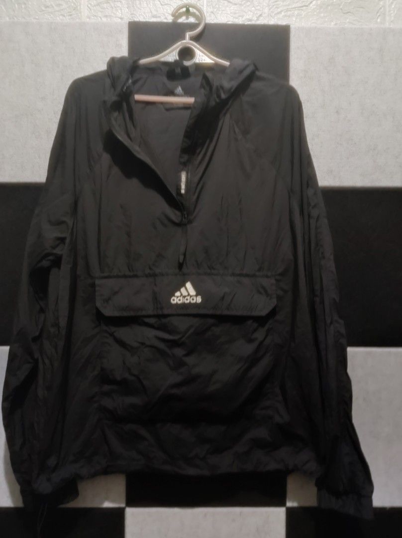 Adidas Black Lightweight Hooded Anorak Jacket (Category: Coats, Jackets and Outerwear) located in Dasmarinas. Submitted by crlwky (Listing ID 1464639955, Image 1). Description: - Black Adidas Anorak Jacket - Lightweight material, perfect for layering or light rain - Half-zip closure - Large front pocket with zip - Adjustable hood with drawstring - Classic Adidas logo on chest - Ideal for casual wear or sports.