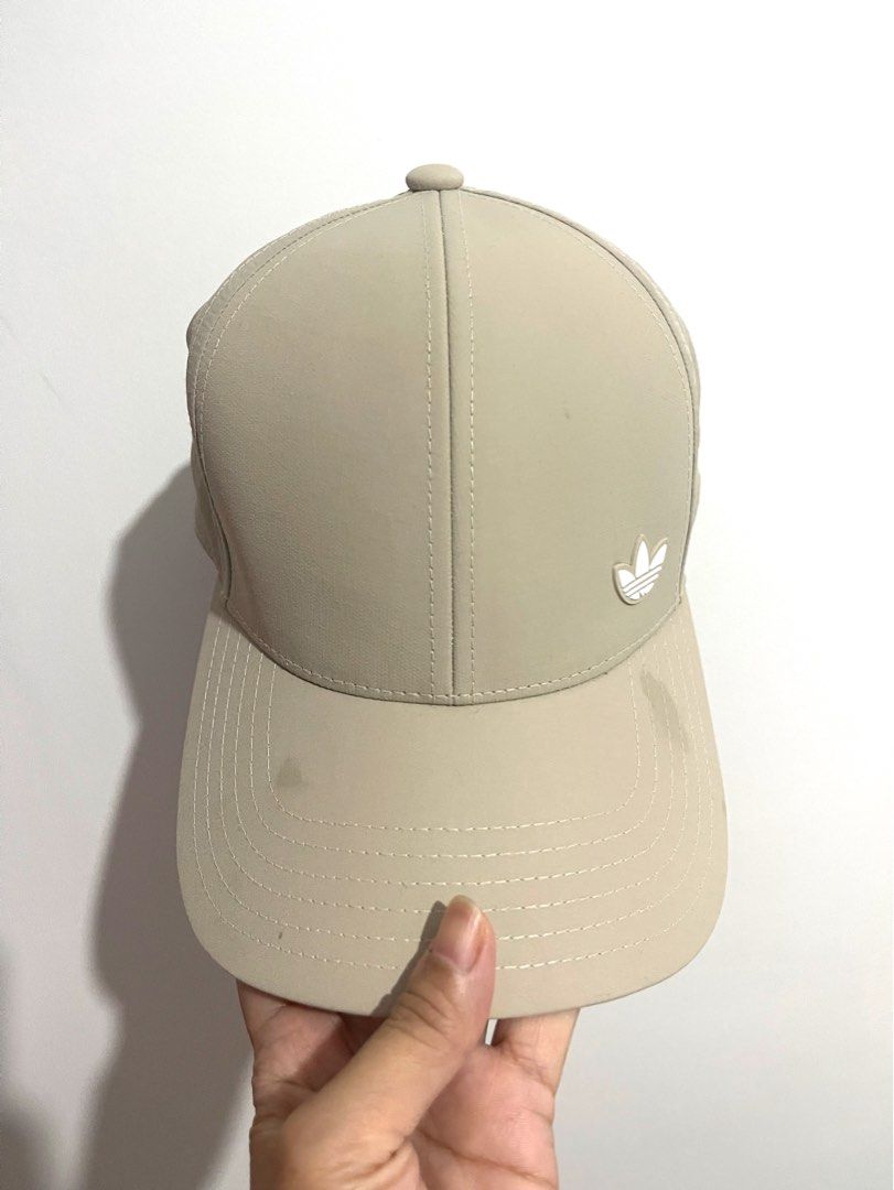 Adidas Cap Beige Trefoil Logo Baseball Hat (Category: Caps & Hats) located in Bulacan. Submitted by akspreloved (Listing ID 1464591965, Image 1). Description: - Classic beige Adidas cap - Features the iconic trefoil logo - Adjustable strap for a comfortable fit - Ideal for everyday wear need lang labhan .