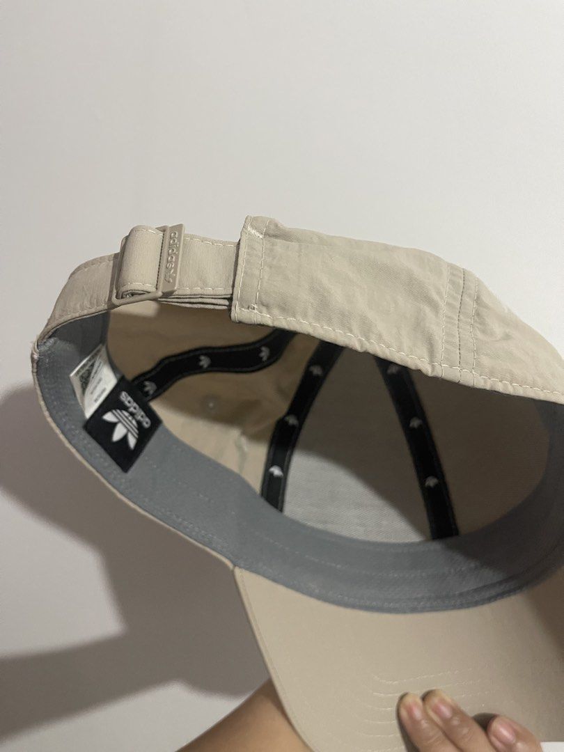Adidas Cap Beige Trefoil Logo Baseball Hat (Category: Caps & Hats) located in Bulacan. Submitted by akspreloved (Listing ID 1464591965, Image 2). Description: - Classic beige Adidas cap - Features the iconic trefoil logo - Adjustable strap for a comfortable fit - Ideal for everyday wear need lang labhan .