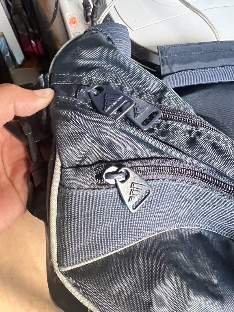 Adidas Duffel Bag Navy Blue (Category: Sling Bags) located in Manila. Submitted by suarezbaby04975 (Listing ID 1464638724, Image 3). Description: - Navy blue Adidas duffel bag - Wide opening main compartment for easy packing - Convenient front zip pocket for essentials - Stylish Adidas logo zipper pulls - Ideal for gym sessions or short trips - Ample interior space for all your gear.