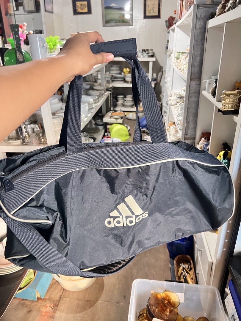 Adidas Duffel Bag Navy Blue (Category: Sling Bags) located in Manila. Submitted by suarezbaby04975 (Listing ID 1464638724, Image 1). Description: - Navy blue Adidas duffel bag - Wide opening main compartment for easy packing - Convenient front zip pocket for essentials - Stylish Adidas logo zipper pulls - Ideal for gym sessions or short trips - Ample interior space for all your gear.
